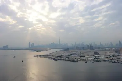 a view of a river with a city in the background at Livbnb - Premium 3BR with Burj Skyline View in Dubai