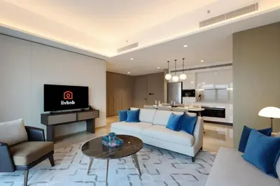 a living room with a couch and a table at Livbnb - Premium 3BR with Burj Skyline View in Dubai