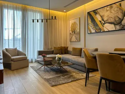a living room with a couch and a table at Bespoke Holiday Homes - Cozy 1BR Retreat in Haven Residences JVC in Dubai