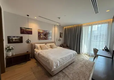 a bedroom with a bed and a large window at Bespoke Holiday Homes - Cozy 1BR Retreat in Haven Residences JVC in Dubai