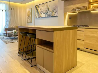a kitchen with a island in the middle at Bespoke Holiday Homes - Cozy 1BR Retreat in Haven Residences JVC in Dubai