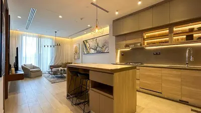a kitchen with a island in the middle of a room at Bespoke Holiday Homes - Cozy 1BR Retreat in Haven Residences JVC in Dubai