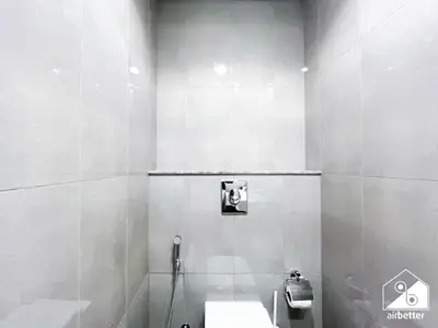 a white bathroom with a toilet and a sink at Luxury 2BR in Merano Tower Panoramic City Views in Dubai