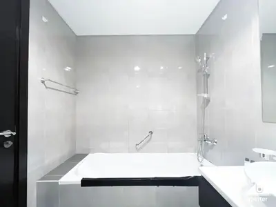 a white bathroom with a tub and a sink at Luxury 2B in Business Bay & Stunning Canal Views in Dubai