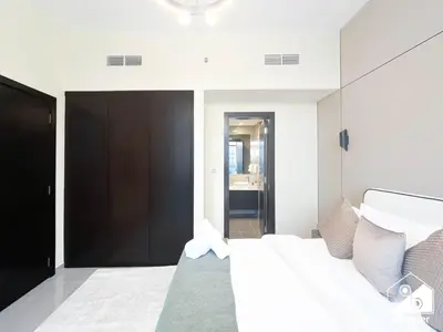 a bedroom with a large white bed and a black door at Luxury 2B in Business Bay & Stunning Canal Views in Dubai