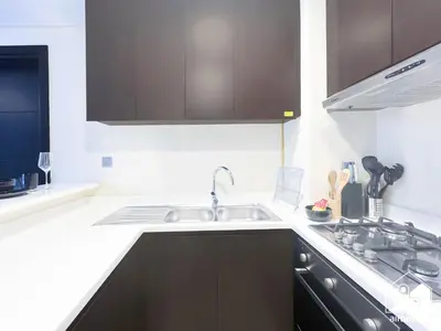 a kitchen with a sink and a stove at Luxury 2B in Business Bay & Stunning Canal Views in Dubai
