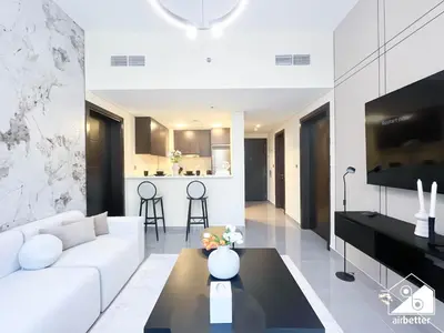 a living room with a white couch and a table at Luxury 2B in Business Bay & Stunning Canal Views in Dubai