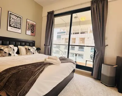 a bedroom with a bed and a large window at Golden Hour Stay Sea View in Marina Dubai in Dubai