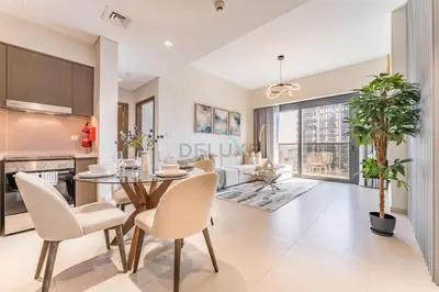 a kitchen and dining room with a table and chairs at Apartment Steps from Burj Khalifa, Dubai Mall & Metro, Act One Act Two Tower 1, Downtown Dubai By Deluxe Holiday Homes in Dubai