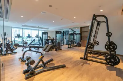 a gym with treadmills and cardio equipment in a building at Apartment Steps from Burj Khalifa, Dubai Mall & Metro, Act One Act Two Tower 1, Downtown Dubai By Deluxe Holiday Homes in Dubai