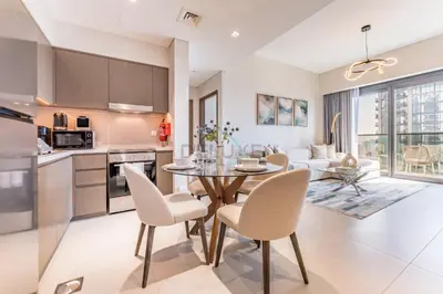 a kitchen and living room with a table and chairs at Apartment Steps from Burj Khalifa, Dubai Mall & Metro, Act One Act Two Tower 1, Downtown Dubai By Deluxe Holiday Homes in Dubai