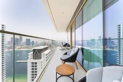 a balcony with chairs and a view of the water at Upscale 2-BR with Sea View - Grand Bleu by Elie Saab in Dubai