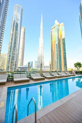 a swimming pool in a city with tall buildings at Majestic ActOne 1BR dowtown Dubai in Dubai