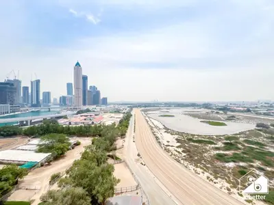 an aerial view of a city with a highway at Stunning 2-Bedroom Apartment with Canal Views in Dubai