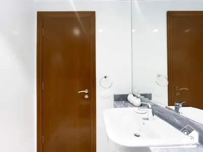 a bathroom with a sink and a mirror at Wonderful 2B with Canal Views at Amna Tower in Dubai