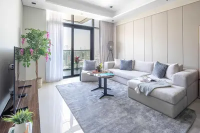 a living room with a couch and a table at Frank Porter - Nobles Tower in Dubai