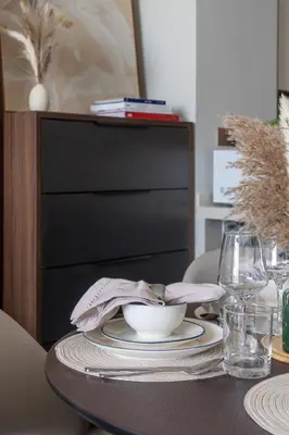 a wooden table with a plate and a bowl on it at Frank Porter - Nobles Tower in Dubai