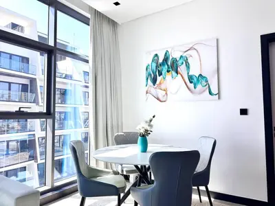 a dining room with a table and chairs and a window at 5 Star Apartment Dubai Burj KhalifaView in Dubai