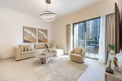 a living room with a couch and a table at 2BR Next to Burj Khalifa& Dubai Mall in Grande Residence in Dubai