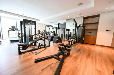 a gym with treadmills and elliptical machines at Comfy 2BR Act 1 Near Dubai Mall in Dubai