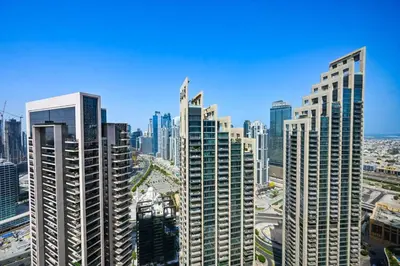 a group of tall buildings in a city at Comfy 2BR Act 1 Near Dubai Mall in Dubai