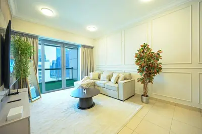 a living room with a couch and a table at Stylish 1BR in 8 Boulevard Walk in Dubai
