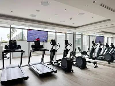 a gym with a bunch of treadmills and cardio machines at Lux 1 Bed room partment in Sobha Creek Vistas Reserve tower at 9th floor in Dubai