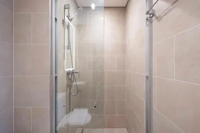 a bathroom with a shower with a toilet at Lux 1 Bed room partment in Sobha Creek Vistas Reserve tower at 9th floor in Dubai