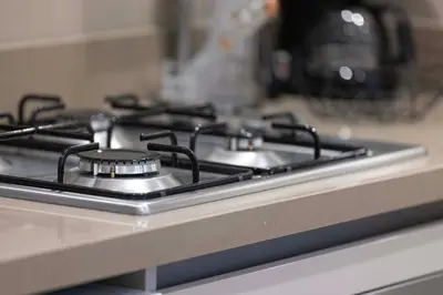 a stove top with four burners on a kitchen counter at Lux 1 Bed room partment in Sobha Creek Vistas Reserve tower at 9th floor in Dubai