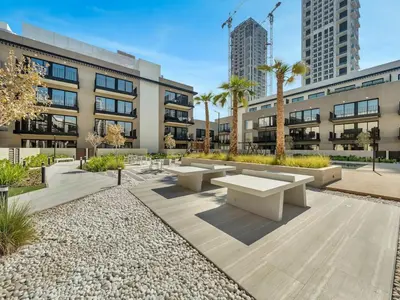 a courtyard with benches in front of a building at Brand New Luxurious 2 Bed in JVC with Padel Court in Dubai