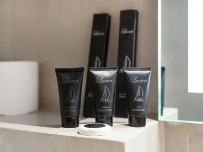 a group of four products sitting on a shelf at Brand New Luxurious 2 Bed in JVC with Padel Court in Dubai