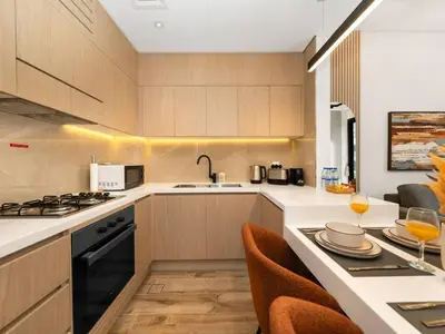 a kitchen with a sink and a stove top oven at Brand New Luxury 2 Bedroom with Padel Gym Pool Cinema in Dubai
