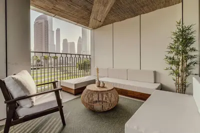a living room with a couch and a chair at Seraya Residence 1 - 4BDR - Burj Views - Amenities in Dubai