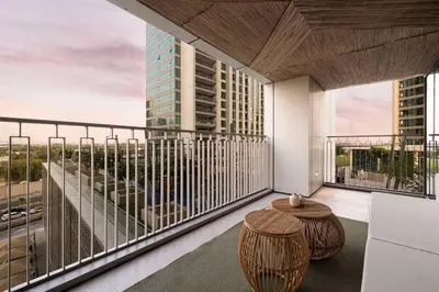 a balcony with a table and a view of a building at Seraya Residence 1 - 4BDR - Burj Views - Amenities in Dubai