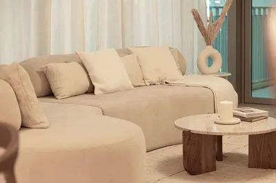 a living room with a couch and a table at Seraya Residence 1 - 4BDR - Burj Views - Amenities in Dubai