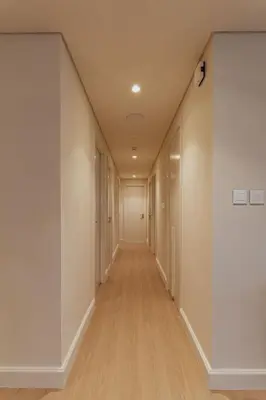a long hallway with white walls and wooden floors at Seraya Residence 1 - 4BDR - Burj Views - Amenities in Dubai