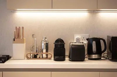 a kitchen counter with various appliances on a counter top at Seraya Residences at Marquise Square Tower in Dubai