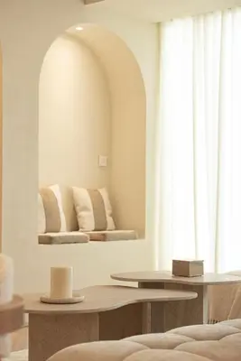a living room with a mirror and a table at Seraya Residences at Marquise Square Tower in Dubai