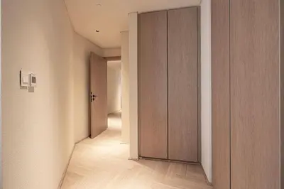 an empty hallway with wooden doors in a room at Seraya Residences at Marquise Square Tower in Dubai