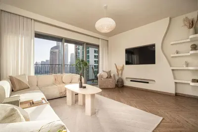 a living room with a couch and a table at Seraya Residence 3 - 4BDR - Burj Views - Amenities and Concierge in Dubai