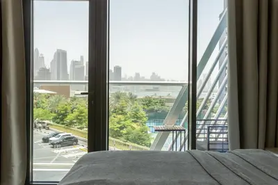 a bedroom with a bed and a view of a city at Sea-View Studio at Seven Palm in Dubai