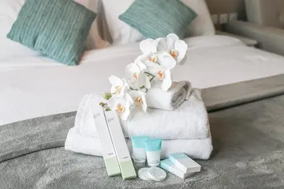 a hotel room with towels and certificates on a bed at Sea-View Studio at Seven Palm in Dubai