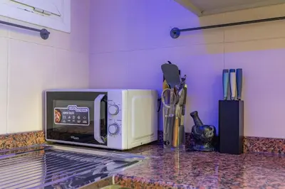 a microwave oven sitting on top of a counter at White Sage High Floor 1BR Metro Access JLT in Dubai