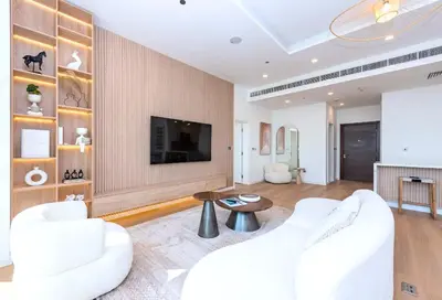 a living room with white furniture and a flat screen tv at Tiara Residence, The Palm - Elegant 1BR with Full Sea View in Dubai