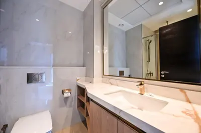 a bathroom with a sink and a mirror at Cozy & Spacious 2 BHK Downtown in Dubai