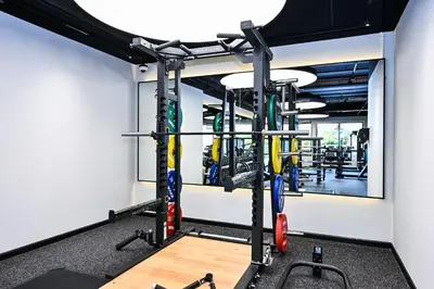 a gym with tread machines and a mirror at Cozy & Spacious 2 BHK Downtown in Dubai