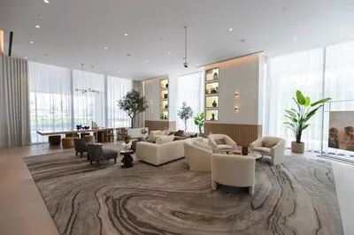 a large living room with couches and a table at Stylish Studio at Berkeley Place by Ellington in Dubai