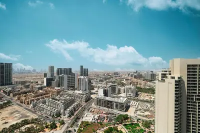 an aerial view of a city with tall buildings at Luxury One-Bedroom Apartment in Bloom Heights in Dubai