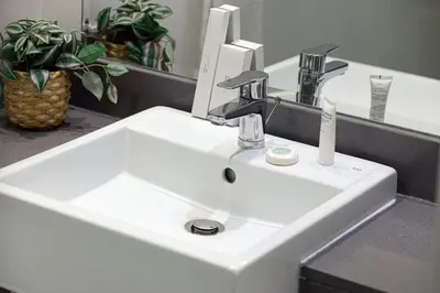 a white sink in a bathroom with a mirror at Luxury One-Bedroom Apartment in Bloom Heights in Dubai