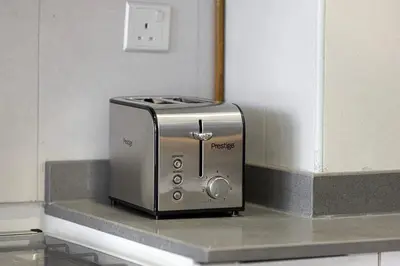 a toaster sitting on a counter in a kitchen at Luxury One-Bedroom Apartment in Bloom Heights in Dubai